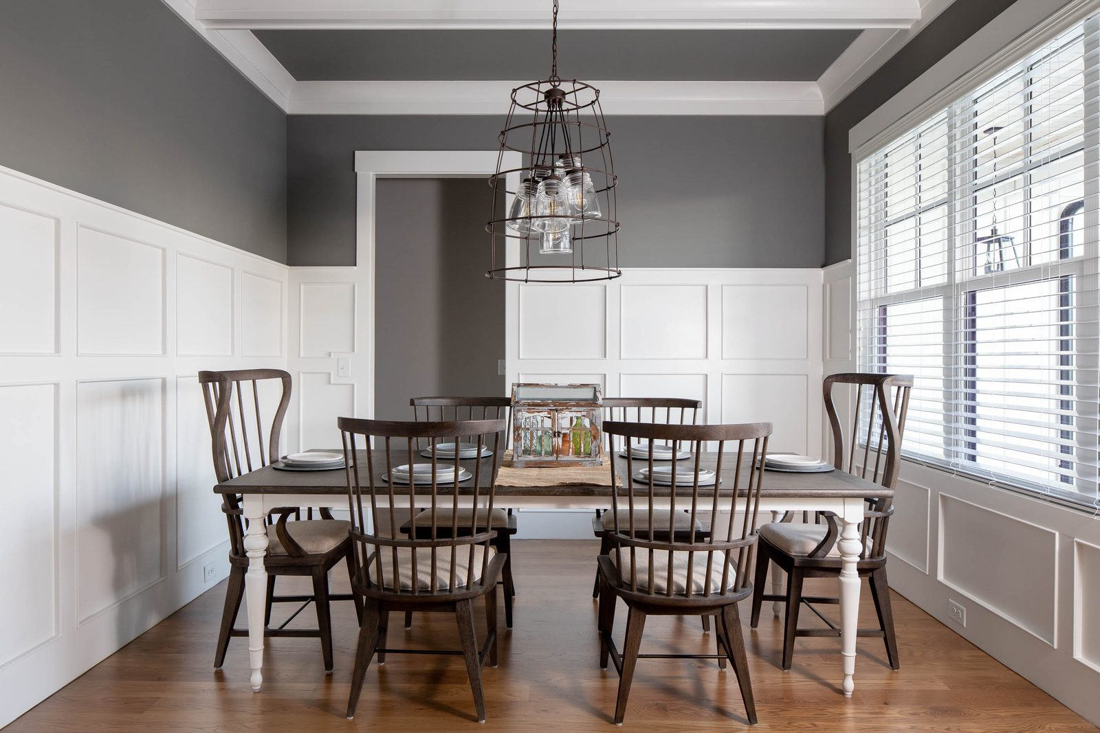 Dining room with spindle chairs and plantation shutters — Glausier, custom home built by Ironwood Construction Group