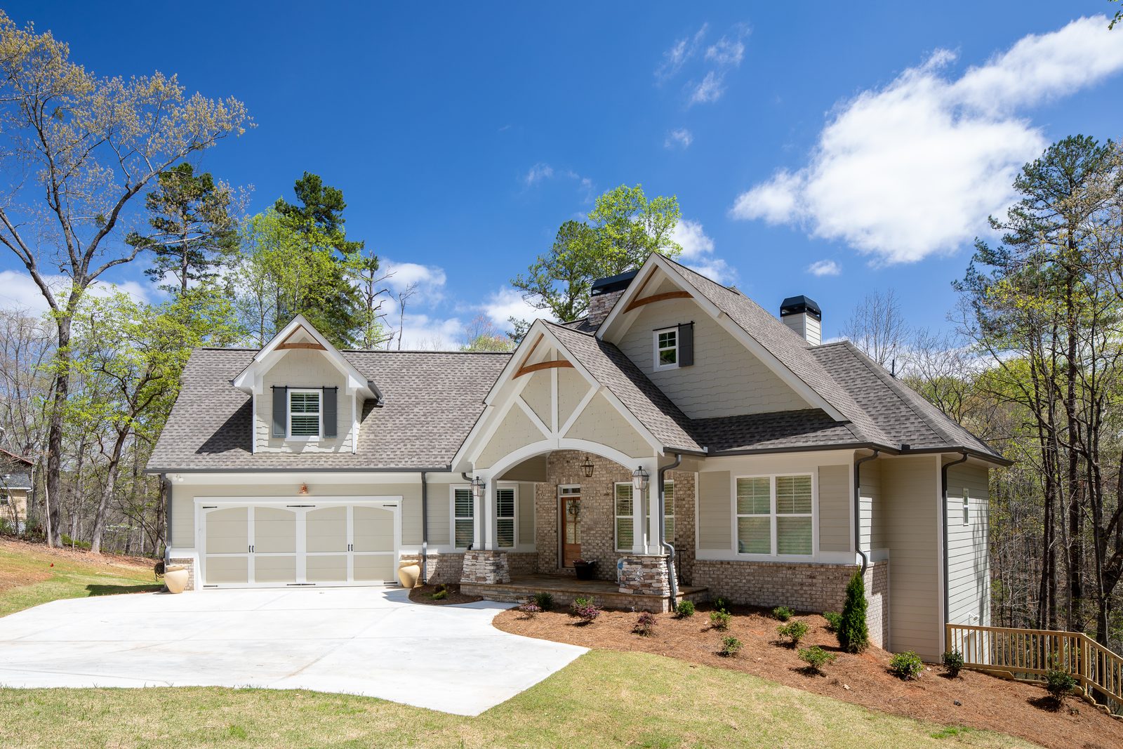 Craftsman front elevation among the trees — Spring 2020 Custom Home, custom home built by Ironwood Construction Group